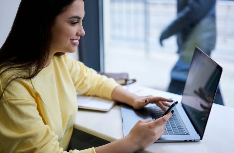 Prosperous hipster girl using technology on remote job