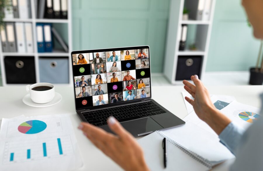 Businessperson Leading Video Conference With Diverse Team Members in Office